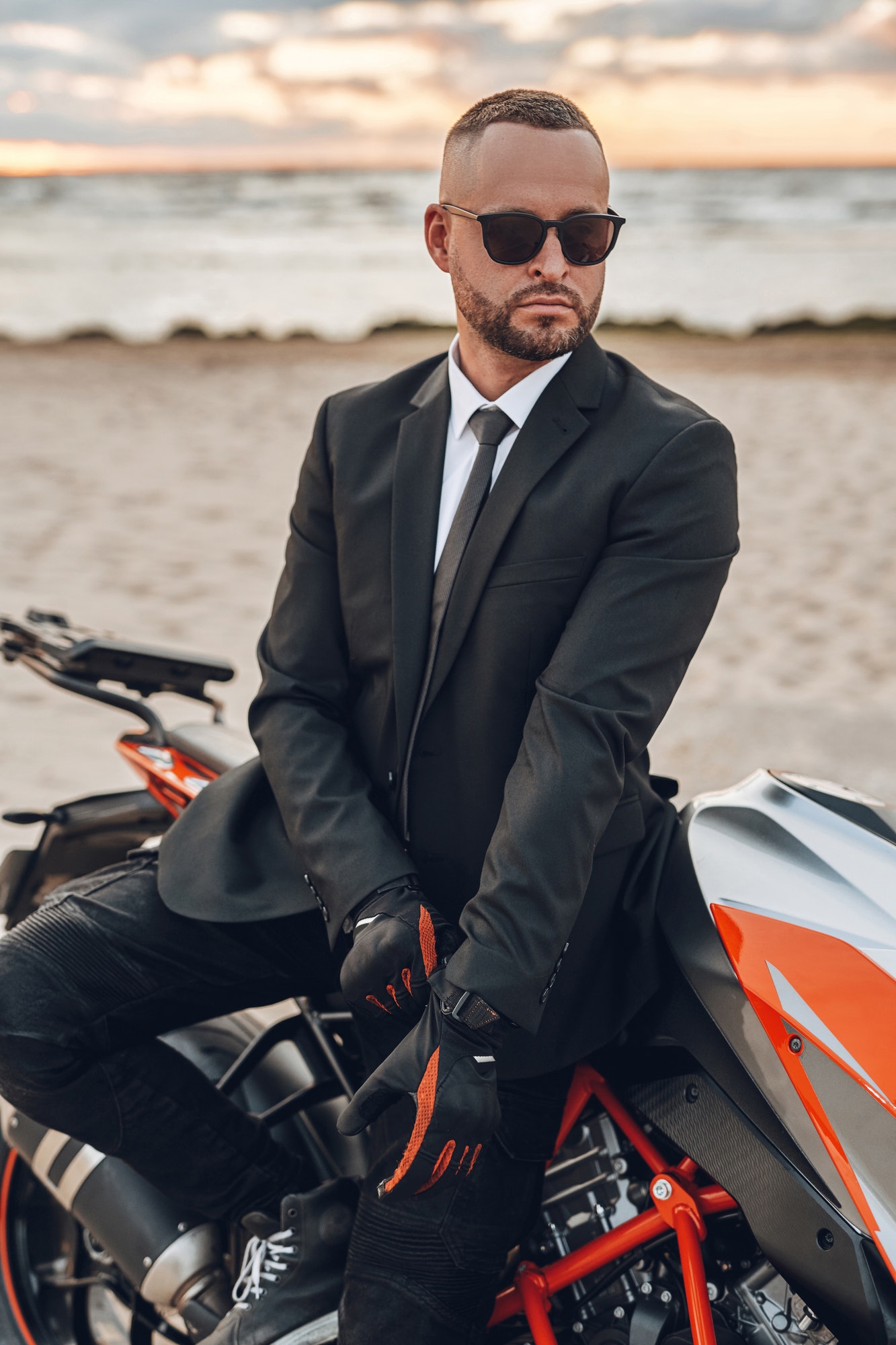 cool-guy-with-sunglasses-and-dark-motorcycle-on-beach